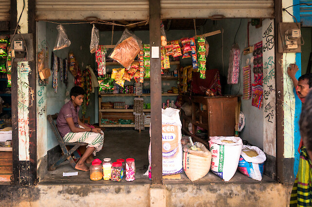 Rezaul likes his open storefront because he is still afraid to go inside buildings. He says he suffers pain in his waist area when he walks for 15 or more minutes.